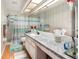 Well-lit bathroom features a skylight, a white marble vanity, and a shower-tub combo at 70 Morning Dove Pl, Oldsmar, FL 34677