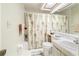 Bright bathroom features a shower-tub combo and modern white vanity with natural lighting from above at 70 Morning Dove Pl, Oldsmar, FL 34677