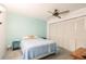 The bedroom has a ceiling fan and double closet doors providing ample storage space at 70 Morning Dove Pl, Oldsmar, FL 34677