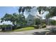 Ardea Country Club entrance with well-manicured landscaping and a glimpse of the beautiful clubhouse, offering luxurious amenities at 70 Morning Dove Pl, Oldsmar, FL 34677