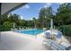 Stunning community pool and lounge area with beautiful landscaping and lots of open seating at 70 Morning Dove Pl, Oldsmar, FL 34677