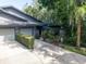 Charming home featuring a well-maintained lawn and an attached two-car garage, nestled among mature trees and landscaping at 70 Morning Dove Pl, Oldsmar, FL 34677