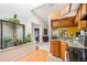 Bright eat-in kitchen with skylight, stainless appliances, wooden cabinets, and adjacent living room at 70 Morning Dove Pl, Oldsmar, FL 34677