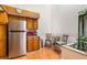 Bright kitchenette features modern appliances, wood cabinets, and eat-in dining area with natural lighting at 70 Morning Dove Pl, Oldsmar, FL 34677
