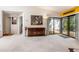 Open living room with neutral carpet, wooden furniture, and sliding glass doors to an outdoor patio at 70 Morning Dove Pl, Oldsmar, FL 34677