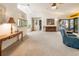 Bright living room with vaulted ceilings, neutral carpet, and sliding glass doors to an outdoor patio at 70 Morning Dove Pl, Oldsmar, FL 34677