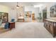 Bright living room with vaulted ceilings, neutral carpet, and adjacent kitchen with stainless steel appliances at 70 Morning Dove Pl, Oldsmar, FL 34677