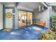 Inviting patio with an open sliding glass door that offers seamless indoor-outdoor living, plus a cozy bench and decorative elements at 70 Morning Dove Pl, Oldsmar, FL 34677