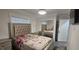 Stylish bedroom featuring a mirrored closet, silver accents and a large, tufted headboard at 7515 Brookhaven Ct, Tampa, FL 33634