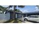 Home's exterior showing solar panels, gray paint, and landscaped yard at 7515 Brookhaven Ct, Tampa, FL 33634
