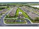 Aerial view of townhome community featuring community pool, landscaping, and ample parking at 7849 52Nd E Ter, Bradenton, FL 34203