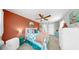 Bright bedroom features unique decor, a ceiling fan, and a warm color scheme at 7849 52Nd E Ter, Bradenton, FL 34203