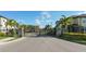 Gated community entrance with stone pillars, black iron fence, palm trees, and manicured landscaping at 7849 52Nd E Ter, Bradenton, FL 34203