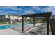 Relaxing community pool area with lounge chairs and pergola shading at 7849 52Nd E Ter, Bradenton, FL 34203