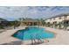 Large community pool and cabana with ample seating, palm trees and nearby townhomes at 7849 52Nd E Ter, Bradenton, FL 34203