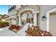 Inviting entrance features an arched entryway, columns, and lush landscaping leading to the front door at 7849 52Nd E Ter, Bradenton, FL 34203