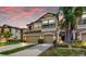 Beautiful two-story home featuring a two-car garage, well-kept lawn, and lush landscaping at sunset at 7849 52Nd E Ter, Bradenton, FL 34203