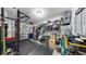 Organized home gym set up in garage with rubber mat flooring and weight-lifting equipment at 7849 52Nd E Ter, Bradenton, FL 34203