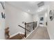 Hallway features carpet flooring, decorative railings and decor that offers an inviting transition between floors at 7849 52Nd E Ter, Bradenton, FL 34203