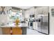 Bright kitchen boasts stainless appliances, white cabinetry, an island with seating, and coastal decor at 7849 52Nd E Ter, Bradenton, FL 34203