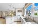 Bright kitchen with stainless steel sink, marble counters, white cabinetry, and an open concept feel at 7849 52Nd E Ter, Bradenton, FL 34203