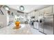 Bright kitchen boasts stainless appliances, white cabinetry, an island with seating, and coastal decor at 7849 52Nd E Ter, Bradenton, FL 34203
