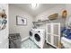 Efficient laundry room with modern appliances, shelving, and a storage cabinet at 7849 52Nd E Ter, Bradenton, FL 34203