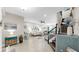 Comfortable living room with stylish decor, tile floors, a staircase, and access to other rooms at 7849 52Nd E Ter, Bradenton, FL 34203