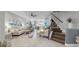 Bright, open living room with a staircase, modern decor, and a seamless transition to other living spaces at 7849 52Nd E Ter, Bradenton, FL 34203
