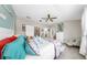 Bright main bedroom featuring coastal decor, ceiling fan, and ensuite bathroom at 7849 52Nd E Ter, Bradenton, FL 34203