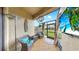 Relaxing screened-in patio offers comfortable seating, outdoor decor, and a view of the backyard at 7849 52Nd E Ter, Bradenton, FL 34203