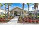 Charming pool entrance building with tropical landscaping and designated accessible parking at 7849 52Nd E Ter, Bradenton, FL 34203