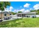 Large backyard featuring a covered patio, backyard house, green grass, and a privacy fence at 801 Kirkcaldy Way, Valrico, FL 33594
