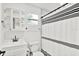 Bright bathroom featuring a modern vanity, toilet, and a shower with a striped curtain at 801 Kirkcaldy Way, Valrico, FL 33594