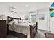Comfortable bedroom with wooden furniture, a window, and bright natural light at 801 Kirkcaldy Way, Valrico, FL 33594