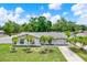 Landscaped front lawn of a single-story home with palm trees and driveway at 801 Kirkcaldy Way, Valrico, FL 33594