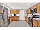 Well-lit kitchen featuring stainless steel appliances, wood cabinetry, and white countertops at 801 Kirkcaldy Way, Valrico, FL 33594