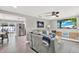Open-concept living room with a comfortable gray sofa and a modern TV setup at 801 Kirkcaldy Way, Valrico, FL 33594