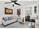 Cozy living room featuring neutral-toned furniture and a view of the bedroom through an open doorway at 801 Kirkcaldy Way, Valrico, FL 33594