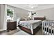 Comfortable bedroom with a large bed, dark furniture, and soft lighting at 801 Kirkcaldy Way, Valrico, FL 33594