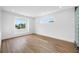 Bright, minimalist bedroom with hardwood floors, large windows, and modern glass block detail at 805 Paris S Ave, St Petersburg, FL 33701