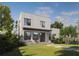 Modern two-story home featuring a sleek design, a well-manicured lawn and lush tropical landscaping at 805 Paris S Ave, St Petersburg, FL 33701
