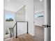 Upstairs hallway featuring modern railings, hardwood floors, and plenty of natural light at 805 Paris S Ave, St Petersburg, FL 33701