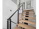 Modern staircase design with wooden steps, black metal railings, and an open, airy feel at 805 Paris S Ave, St Petersburg, FL 33701