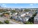 Expansive aerial view capturing the community with its townhouses, greenery, and the city skyline in the distance at 834 N Oregon Ave, Tampa, FL 33606