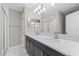 Modern bathroom features double sinks, quartz counters, and a glass enclosed shower at 834 N Oregon Ave, Tampa, FL 33606
