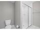 Modern bathroom featuring a glass-enclosed shower with tile surround and updated fixtures at 834 N Oregon Ave, Tampa, FL 33606