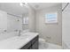 Bathroom featuring a sink, white quartz countertop, shower with tub, and white tile at 834 N Oregon Ave, Tampa, FL 33606