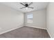 Bedroom featuring a ceiling fan, window, and neutral colored walls and carpet at 834 N Oregon Ave, Tampa, FL 33606