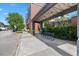Building exterior featuring a covered walkway with bench seating and greenery along the walkway at 834 N Oregon Ave, Tampa, FL 33606